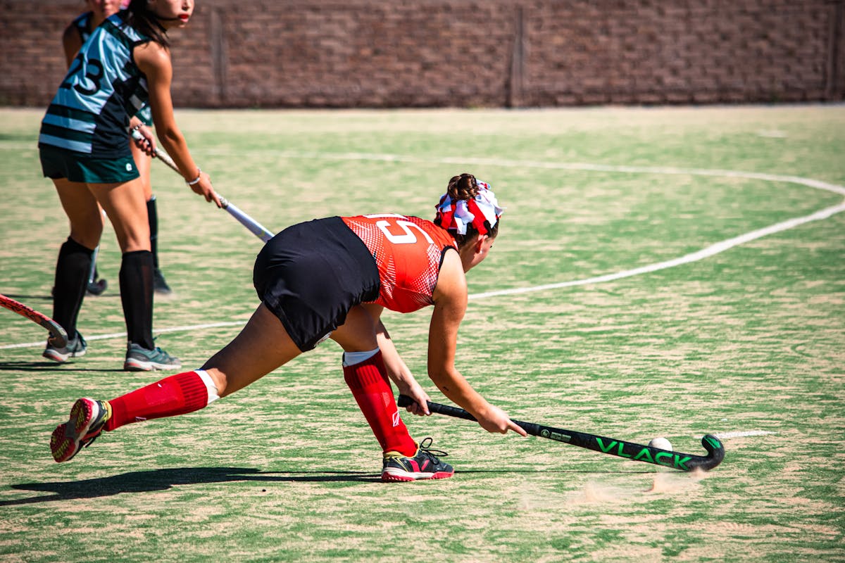 Youth field hockey players training indoors